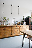 Kitchen with wooden worktop and vintage cupboard, pendant lights