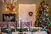 Festively decorated dining area with Christmas tree and candlelight