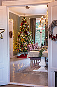 Dining room decorated for Christmas with Christmas tree and chandelier