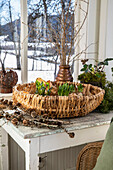 Woven basket with plants on wooden table