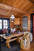 Rustic living room with wood panelling and candles on the table