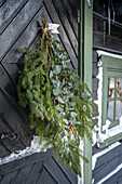 Door wreath made of fir branches and eucalyptus in winter