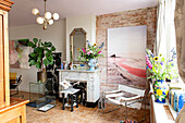 Living room with exposed brick wall, large picture and fireplace