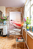 Living room with parquet floor, fireplace and colorful bouquets of flowers