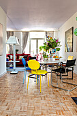 Dining area with colorful chairs and parquet flooring