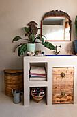 Washbasin with vintage mirror and storage space in the bathroom