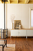 Scandinavian-style sideboard with decoration and fireplace