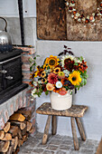 Autumnal bouquet of flowers on a rustic wooden stool