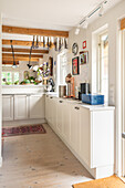 Country kitchen with wooden beams and white furnishings