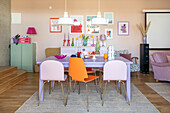 Colourful dining area with modern chairs and wall decorations