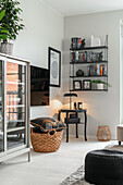 Living room with black shelving, TV and plant