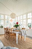 Bright dining area with wooden table and chairs, Christmas decorations