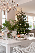 Christmas dining table with Christmas tree in the background