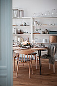 Christmas-themed dining table and Scandinavian-style shelving unit