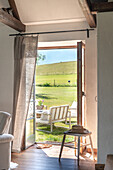 View of green hills from a rural living room