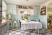 Country kitchen with chequerboard floor and dining area