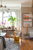 Living room with wooden furniture and framed poster on the wall