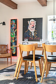 Dining area with modern chairs and pictures on the wall