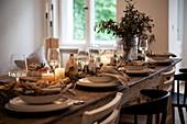 Set dining table with candles and plant decoration in the dining room