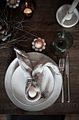 Easter table setting with bunny-shaped napkin and quail eggs