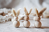 DIY Easter bunnies made from wooden baubles with bunny ears made from dried flowers