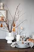 Easter table setting, vase with twigs and decorations