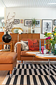 Living room with leather sofa and black and white striped carpet