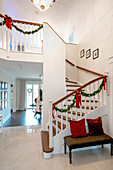 Staircase with Christmas decorations and bench in the entrance area