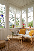 Conservatory with rattan furniture and terracotta flower pots