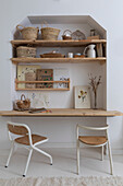 Work area with wall shelves, baskets and botanical drawings