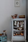 White wardrobe with toys and dolls' clothes in the children's room