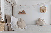 Light-coloured bedroom with decorative garland