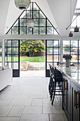 Modern kitchen with glass pendant lights and glass doors to the garden