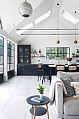 Modern kitchen with dining area, pendant lights and skylights