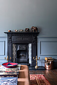 Black fireplace with elephant decoration and candle holders in the living room