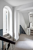 Hallway with striped carpet and white walls in a classic house