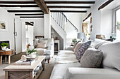 Bright living room with exposed beams and cosy seating area