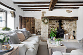 Rustic living room with natural stone wall and wooden beamed ceiling