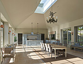 Kitchen and dining area in spacious living room with a skylight