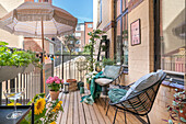 Gemütlicher Balkon mit Pflanzen und Sitzgelegenheiten im Sommer