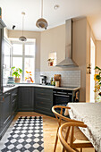 Modern kitchen with dark cupboards and geometric carpet