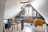 Attic as children's room with table and cosy seating area