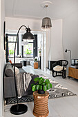 Bright living room with arc lamp and contrasting ethnic-style textiles