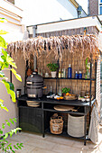 Outdoor kitchen with bamboo paneling and modern ceramic grill