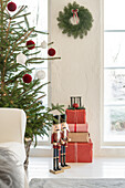 Room decorated for Christmas with Christmas tree, presents and nutcracker figurines