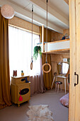 Children's room with vintage cupboard and ring swing