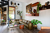 Living room with vintage leather sofa and eclectic decoration