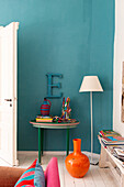 Living room with turquoise wall and colourful vintage decorations