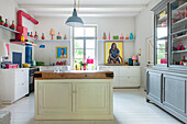 Bright kitchen with colourful accents and central cooking island