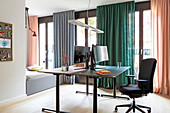 Modern furnished study with different coloured curtains